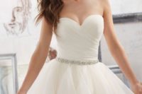 05 a rhinestone and pearl bridal sash is the only jewelry piece on the bride and it’s amazing