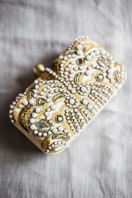 a whimsy art deco inspired wedding clutch with gold beads, vintage detailing and pearls for a pretty touch