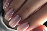 05 nude manicure with a rose gold half moon accent to add a glitter touch to the look