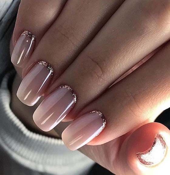 nude manicure with a rose gold half moon accent to add a glitter touch to the look