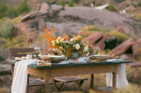 06 The wedding table setting was done with an airy table runner, with a lush fall-inspired boho floral centerpiece
