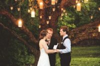 06 lanterns and candle holders on a tree create a cozy and intimate space ideal for a wedding ceremony