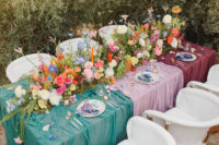 07 The wedding table was dressed up with colorful textiles, bold flowers and striped napkins and orange candles