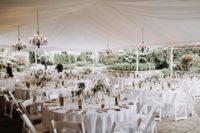 07 The wedding tent was decorated with glam chandeliers and in a neutral color palette