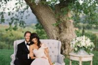 07 a romantic glam space with a vintage sofa and an overiszed glam chandelier for the wedding portraits