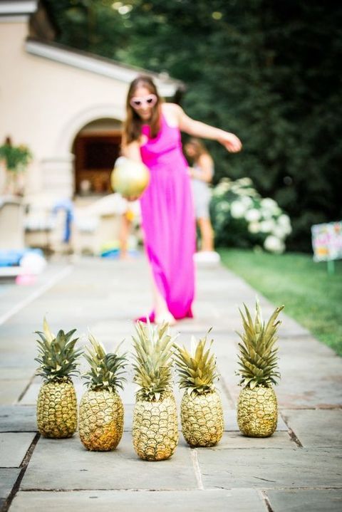 fun tropical bridal shower bowling with gilded pineapples is a great activity idea