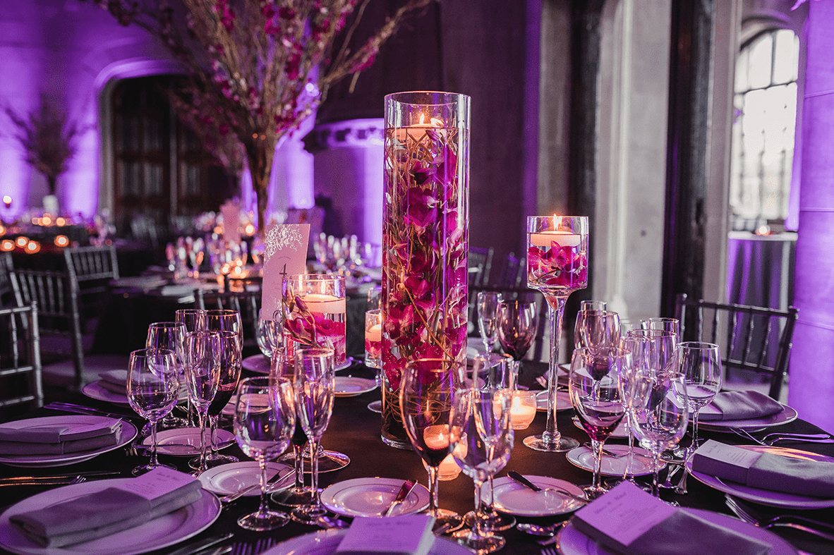 The wedding tablescape was done with purple blooms and floating candles, it looked very beautiful