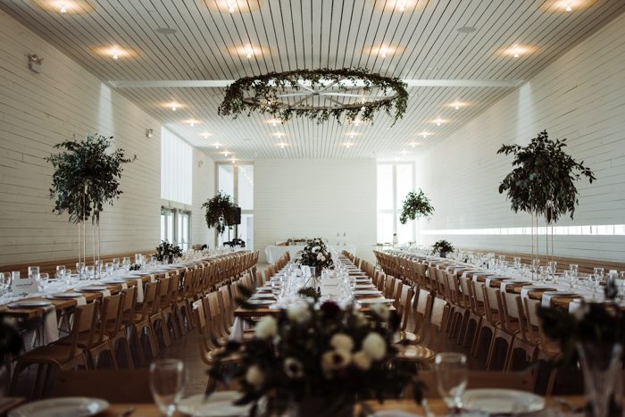 The wedding venue was a white and serene one, done with greenry touches - centerpieces and chandeliers
