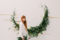 09 a crescent moon foliage wedding arch with gold tape and green garland for a natural feel
