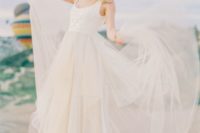 blush wedding dress with a scoop neckline