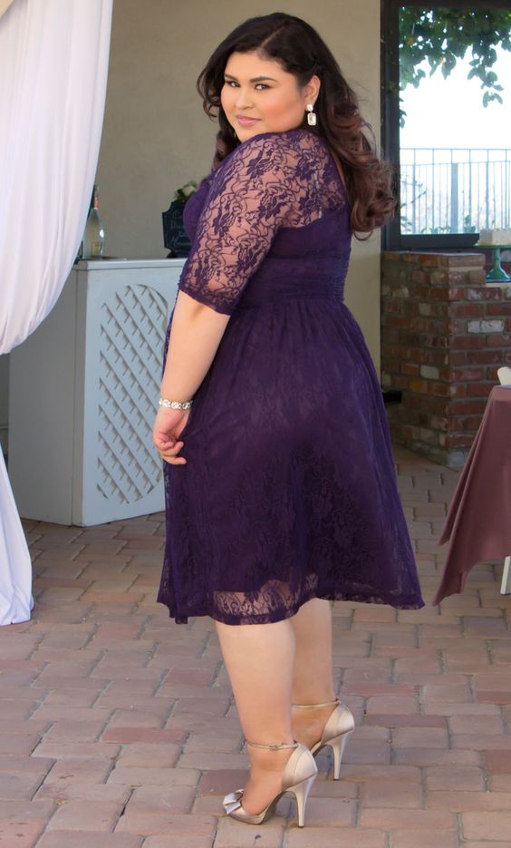 a plus size purple lace midi dress with half sleeves and an illusion neckline