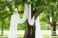 10 hang some light and sheer fabric on the tree to create a natural ceremony space