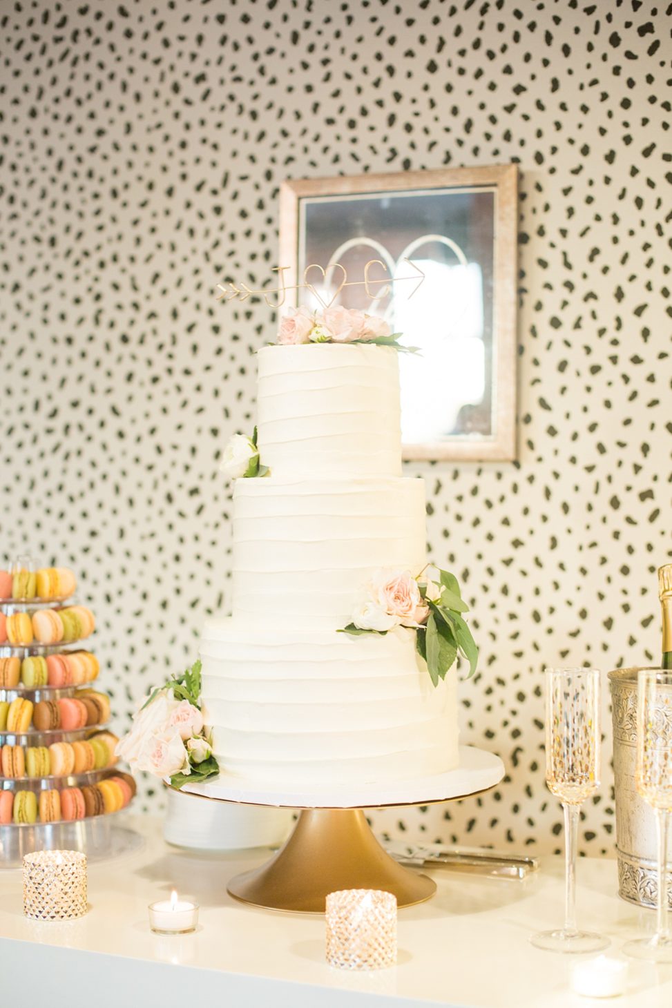 The wedding cake was a buttercream one, with blush and ivory blooms and an arrow topper