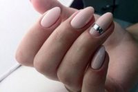 11 blush almond nails with a single metallic stripe on one nail for a contemporary feel
