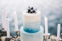 11 buttercream is ideal for decorating the cake with watercolor, here an ombre blue wedding cake with blueberries and thistles