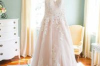 12 a princess-styled light pink wedding dress with white lace appliques on the bodice and skirt trim