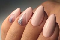 12 blush almond nails with silver glitter triangles as accent for a cute touch