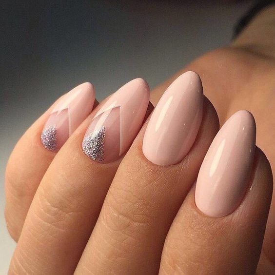 blush almond nails with silver glitter triangles as accent for a cute touch