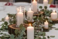 12 rustic centerpiece with greenery, wood slices and pillar candles for an elegant rustic tablescape