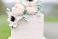 13 a simple rustic wedding cake with textural buttercream and some blooms on top