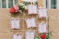14 a cute bird cage with bright blooms and greenery and floral escort cards