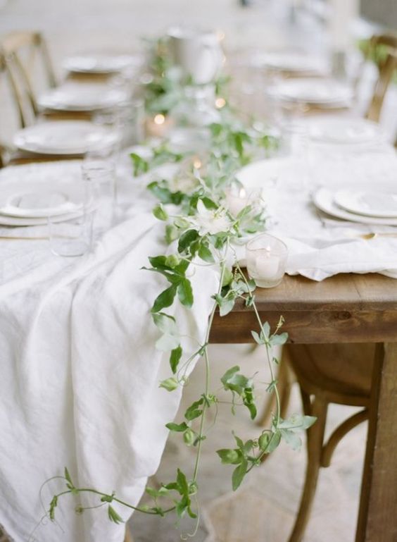 a subtle fresh greenery table runner and some candles to add charm to the table
