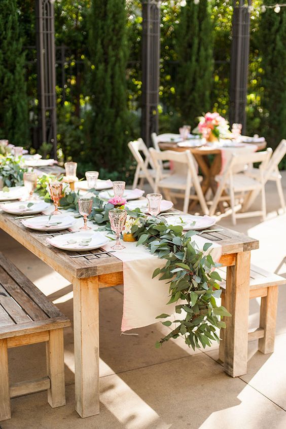 rustic table decor with a blush runner, a fresh leaf runner and colored glasses for a summer rustic shower