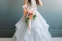 15 a gorgeous lace bodice with cap sleeves and heavy embellishments and a full layered light blue skirt make the dress a statement