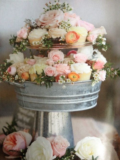 a rustic cupcake stand of galvanized buckets with greenery and flowers