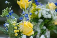 16 a wedding centerpiece of blue and yellow flowers in a mason jar is a cute idea for a rustic wedding
