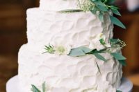 16 a white textural wedding cake topped with white blooms and greenery for an elegant rustic wedding