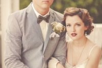 16 rust-colored pants, a white shirt, a grey jacket, a grey velvet bow tie for a 1920s inspired wedding