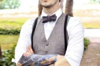17 a dapper groom’s look with a grey vest, black pants and suspenders, a bow tie and a cap
