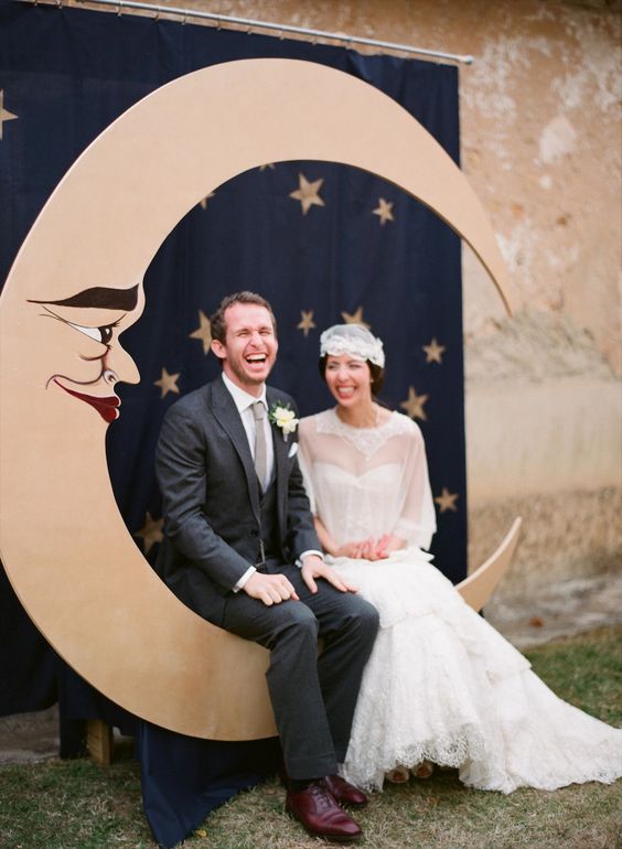 a vintage crescent moon wedding photo booth backdrop, a curtain to imitate a night sky with stars