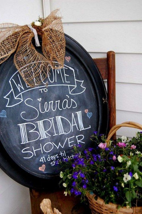 an oval chalkboard sign with a burlap bow for decorating your rustic bridal shower