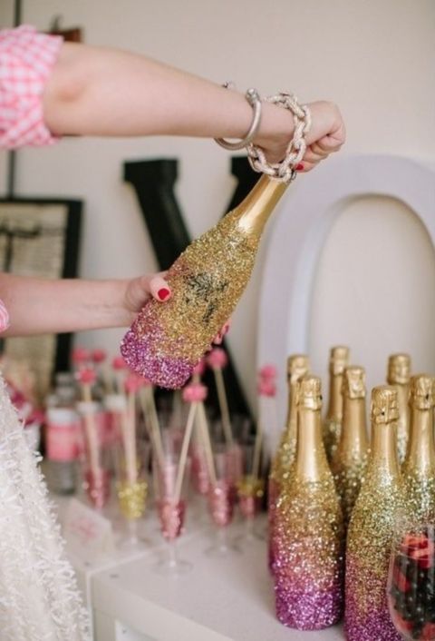 champagne bottles covered with gold and pink glitter for a glam bridal shower