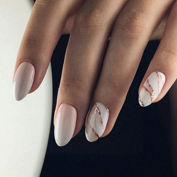ombre French manicure with marble accents and rose gold accents for a trendy touch