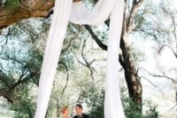 19 hang some ethereal white fabric on a tree branch to create an arch – nothing else is needed