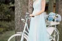 20 a light blue wedding dress with lace cap sleeves, a deep V-neckline, a layered skirt looks very delicate