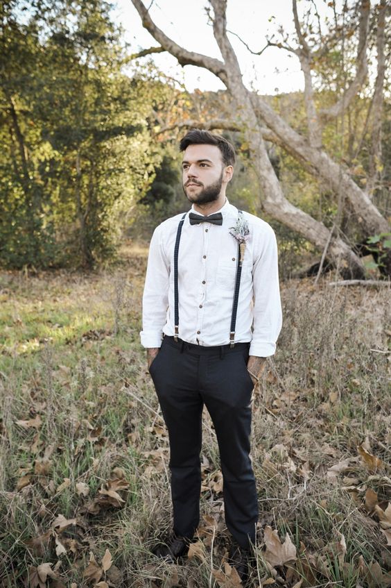 black pants and suspenders, a black bow tie and a white with black buttons