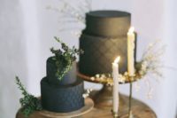 21 a couple of black textural wedding cakes with greenery on top for a minimalist wedding
