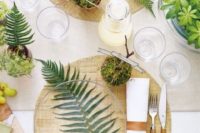 21 a woodland-themed wedding table with ferns, moss and greenery plus some wooden touches