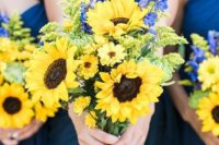 21 navy dresses and sunflower and delphinum bridesmaids’ bouquets for an elegant combo
