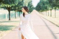 23 a modern bridal look with a lace high neckline wedding dress with long sleeves and a messy hairstyle