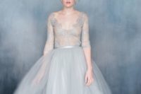 23 a tender light blue wedding dress with a lace bodice and long sleeves and a full tulle skirt