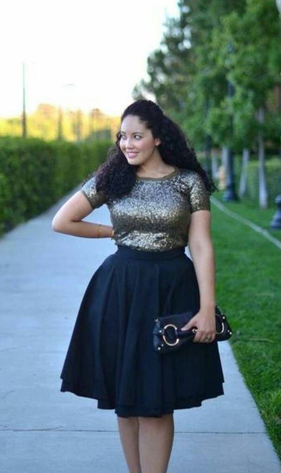 an ensemble of a dark sequin top with short sleeves and a full black A-line skirt