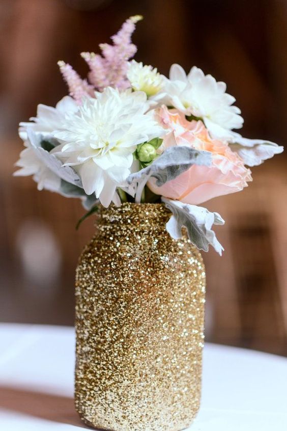 such a glitter mason jar can be made by yourself to use as a vase or centerpiece