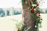 24 a tree decorated with bright floral posies in red and burgundy, with greenery for a fresh touch