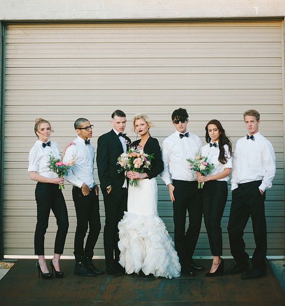 black pants, white shirts and black bow ties for both groomsmen and bridesmaids and a modern look