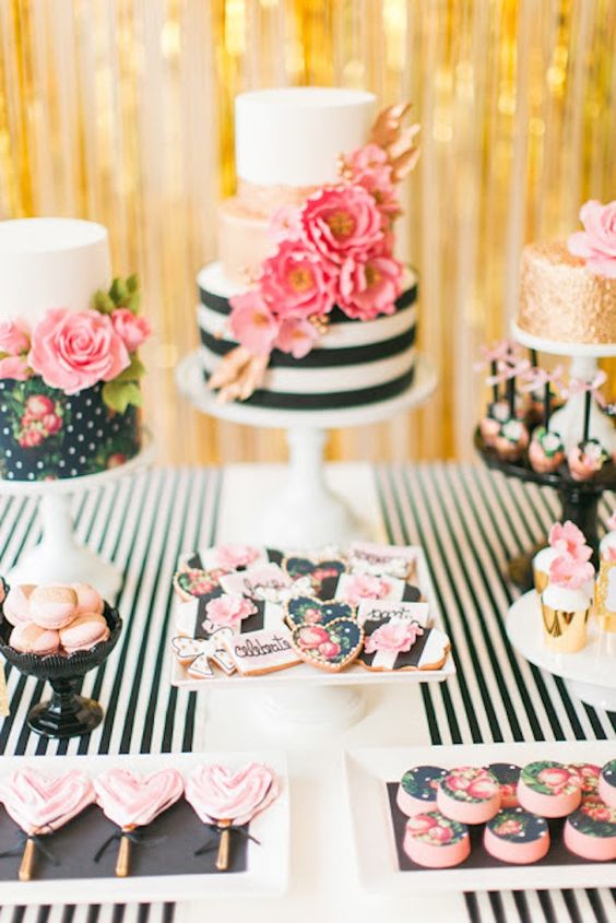 a glam dessert table with an assortment of cakes, cookies and pops with hand painted flowers